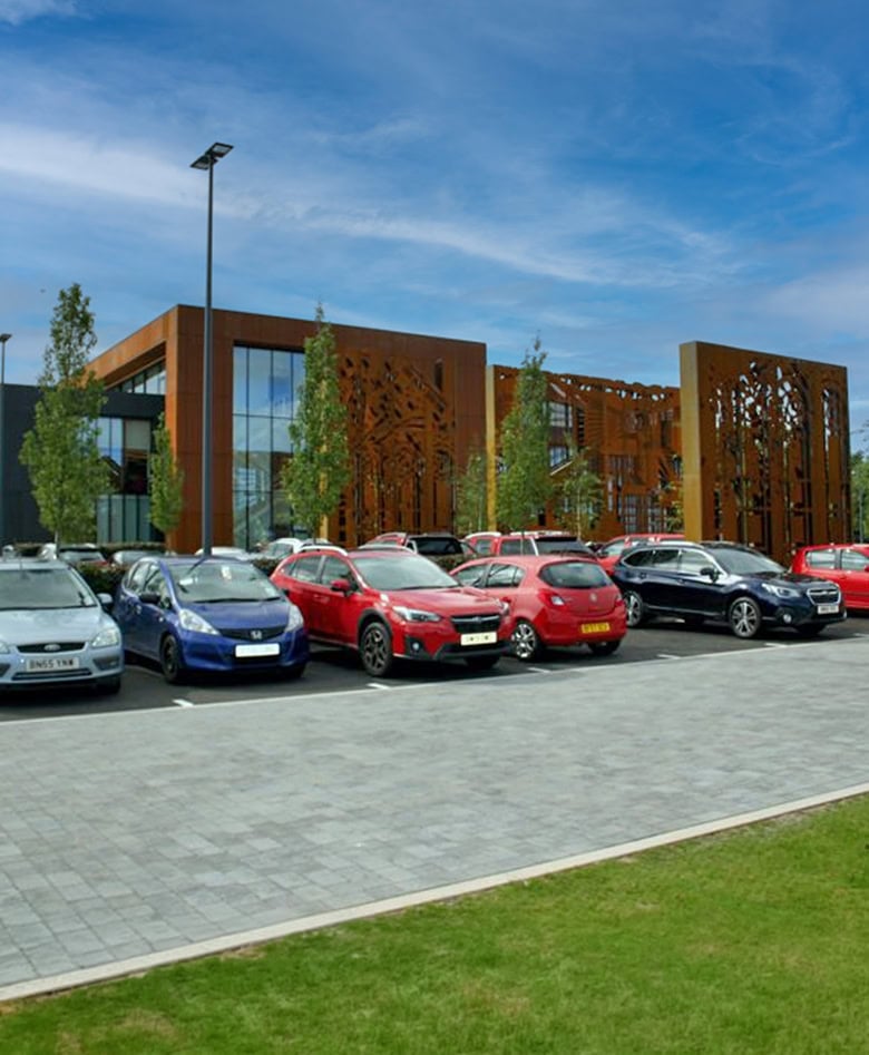 Line of cars parked outside a building